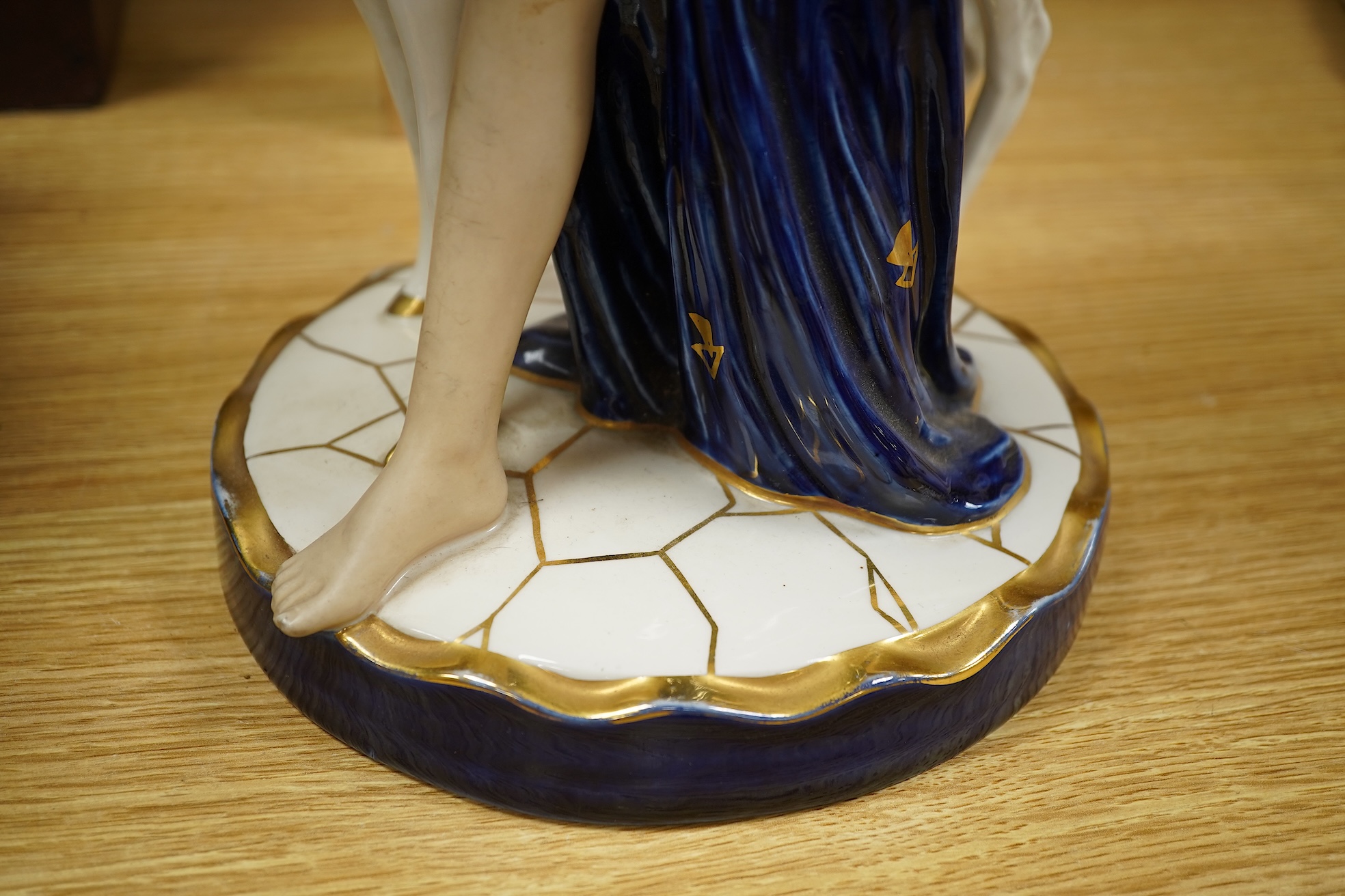 A Royal Dux Art Deco porcelain group of girl with a deer 37.5cm high